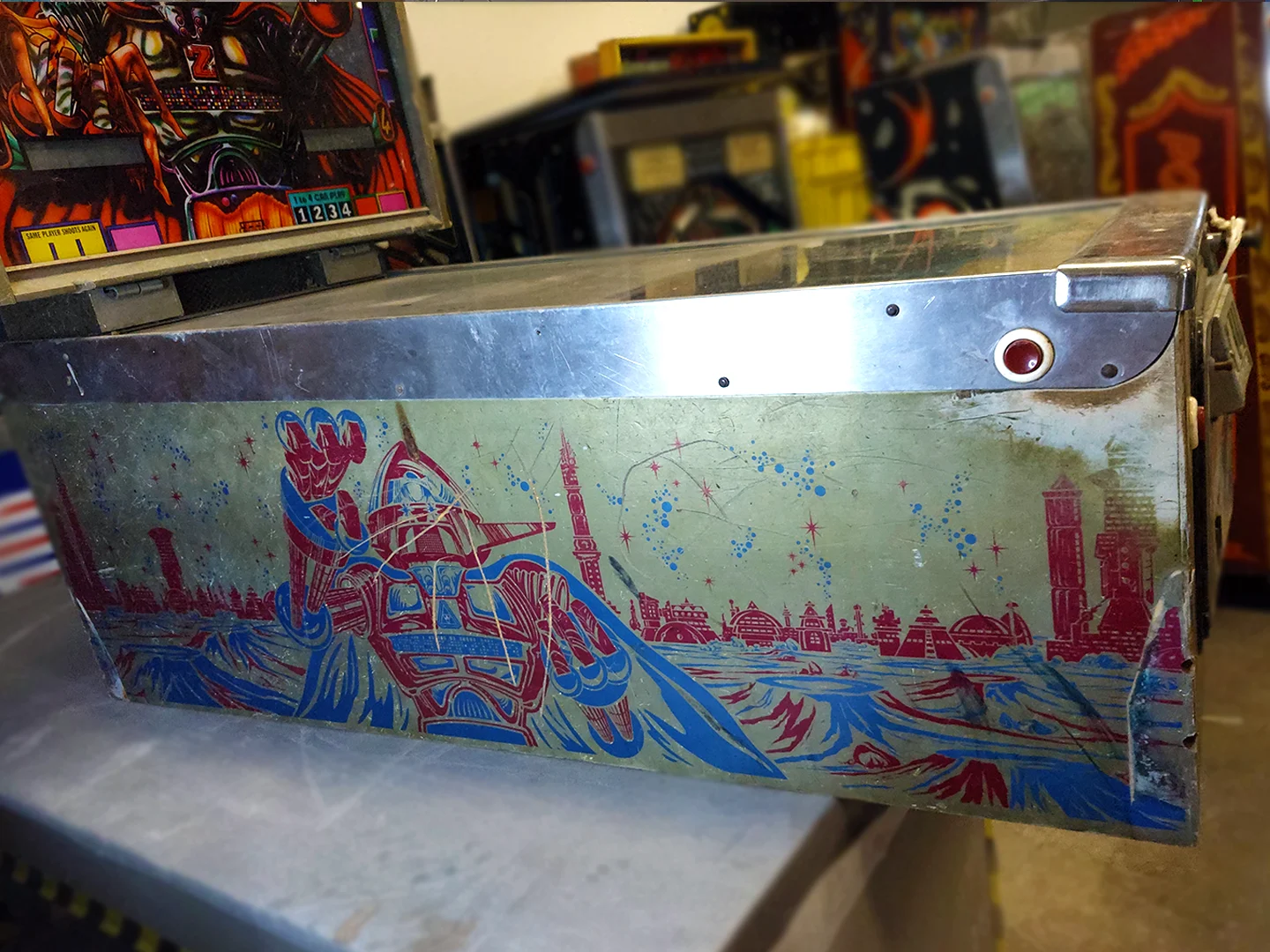 Multiple pinball machines in the Pinball Magic workshop awaiting restoration assessment